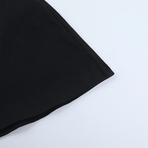 Detail shot of black dress hem with precision double-needle stitching on cotton fabric