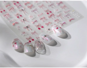 Detailed view of pink bow and rabbit nail art stickers with iridescent pearl finish