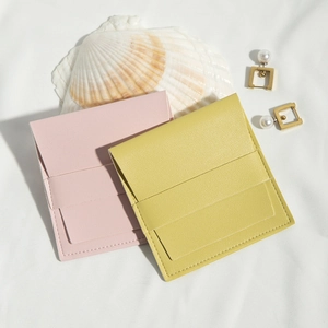 Detail of pink and yellow lychee grain PU leather jewelry pouches with snap closures