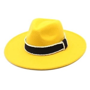 Detail of yellow wool felt fedora with black grosgrain ribbon and white bead trim