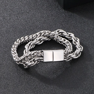 Detail of silver double-layer Cuban link and rope chain bracelet with magnetic clasp