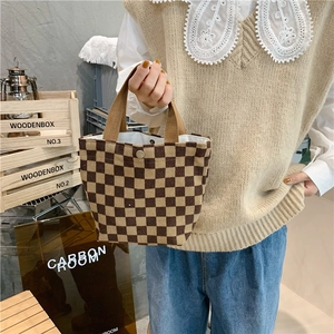 Close-up of retro corduroy checkerboard tote bag with metal snap and thick handle
