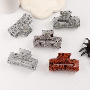 Halloween square hair claws featuring spider, web, and ghost patterns in festive colors