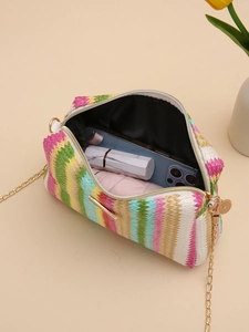 Detail of multi-color woven straw crossbody bag showing interior capacity and gold chain