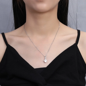Elegant 2 carat zircon pendant necklace with small accent stones on a female model