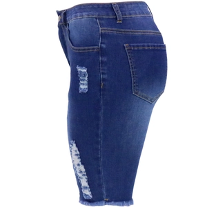 Détail du short en jean bleu avec déchirures latérales et ourlets effilochés