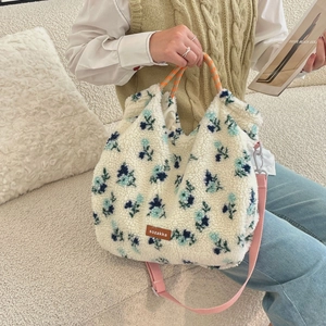 Detail of floral lamb wool tote bag with leather logo patch and woven handle texture
