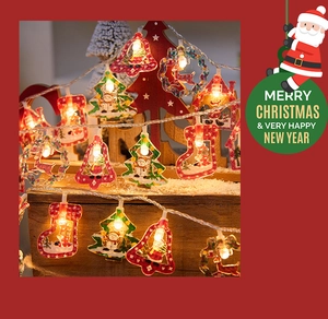 Detail of festive LED string lights featuring colorful Christmas bell and tree acrylic shapes