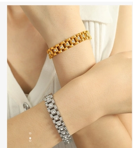 Detailed close-up of gold and silver watch-style bracelets with sparkling zircons