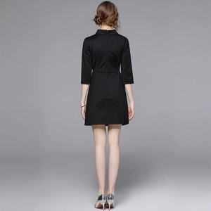 Elegant black mini dress featuring floral embroidery and bow detail shown from the back