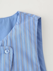 Detailed macro view of V-neckline striped vest with blue buttons and textured fabric