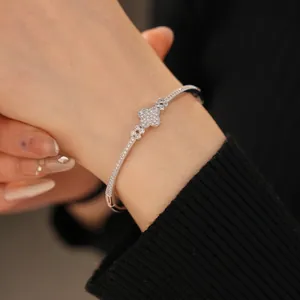Sparkling zircon clover buckle bracelet in silver finish on model's wrist