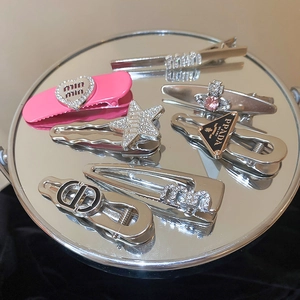 Detailed view of silver and pink Y2K hair clips set with sparkling rhinestone inlay