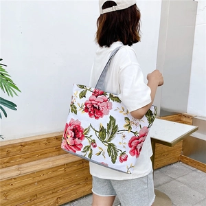 Large floral canvas tote bag with peony print shown as a crossbody shoulder bag