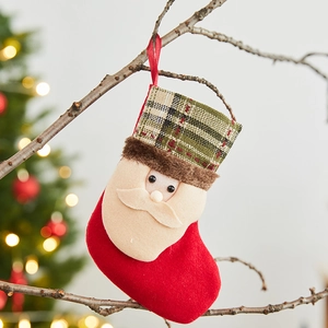 Large red velvet Christmas stocking with plaid cuff and Santa applique on tree branch