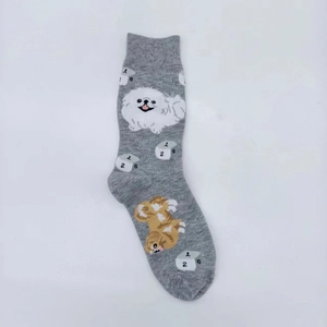 Detailed knit of grey cotton socks featuring cartoon dogs and dice patterns