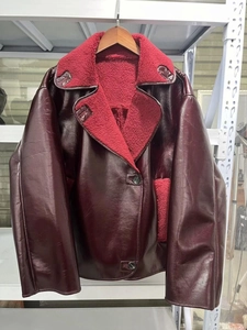 Detailed close-up of dark wine red faux leather jacket with plush shearling lapels