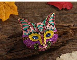 Macro shot of owl brooch with colorful enamel and rhinestones on a rustic wood background