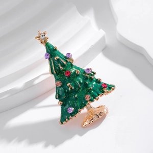 Sparkling Christmas tree brooch with green enamel and colorful rhinestones on white waves