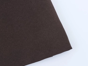 Close-up of thick dark brown canvas fabric texture on women's double-breasted blazer set