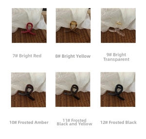 Detail view of twist hair claws in glossy red, yellow, and matte amber resin finishes