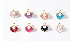 Detailed view of colorful shell pendants with pearls in gold-plated metal settings