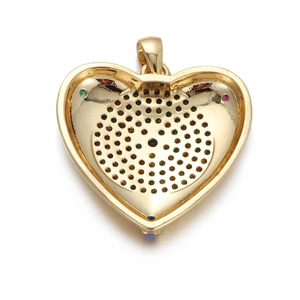 Macro detail of gold-plated heart pendant back with multicolor gemstones and hollow design