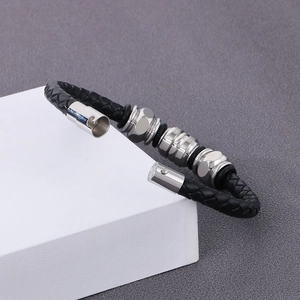 Detail of black braided leather bracelet with silver metal beads and magnetic clasp