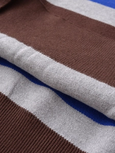 Close-up of soft knit fabric with brown, grey and blue wide horizontal stripes detail