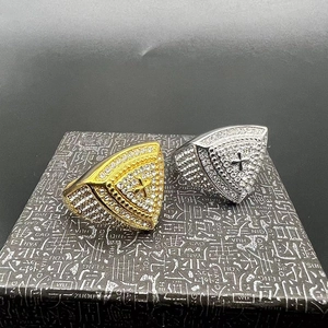 Macro view of gold and silver hip hop rings with triangle face and cross detail