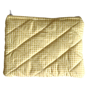 Close-up of yellow plaid cosmetic bag showing quilted texture and fabric details