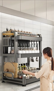 Three-tier dark gray kitchen spice rack detail with knife holder and side cutting board stand