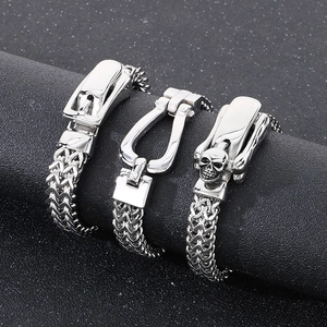 Close-up of double-row dragon bone chain bracelets with a polished skull clasp design