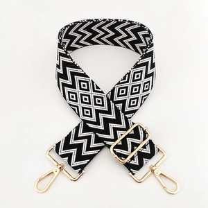 Detail of 5cm adjustable black and white diamond pattern bag strap with gold hooks