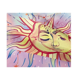Close-up of bohemian sun and stars tapestry showing soft fabric texture and vibrant colors