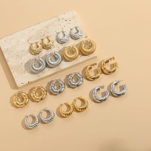 Macro view of vintage geometric hoops with textured patterns and engraved details