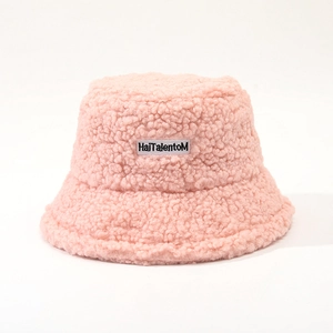 Detailed view of pink lamb wool bucket hat featuring letter embroidery label and soft texture