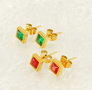 Detail of square zircon stud earrings in gold plated steel with red and green gems