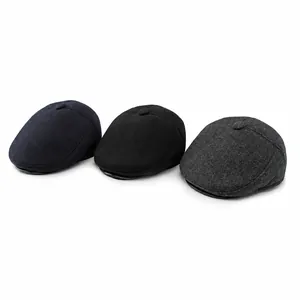 Men's wool flat caps in navy, black, and grey featuring classic British vintage style