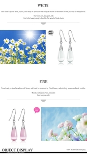 Detail of teardrop cat eye stone earrings in milky white and rose pink with silver hooks