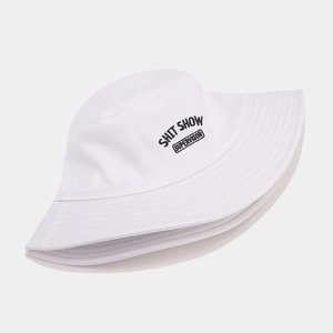Close-up of black SHIT SHOW embroidery on white cotton fisherman bucket hat