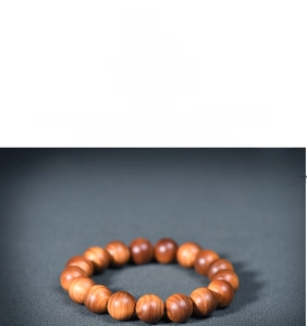 Macro detail of natural aging Thuja wood beads showing rich oil texture and wood grain