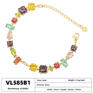 Detail view of brass rainbow gemstone bracelet with mixed-cut zircon and heart charm