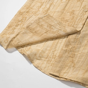 Detailed macro view of sand beige jacquard fabric with delicate floral embroidery texture