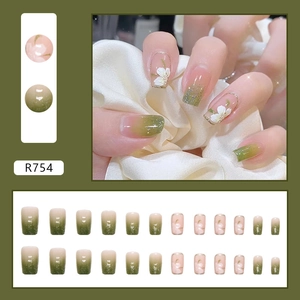Faux ongles adhésifs dégradé vert forêt avec fleurs de camélia blanc et paillettes