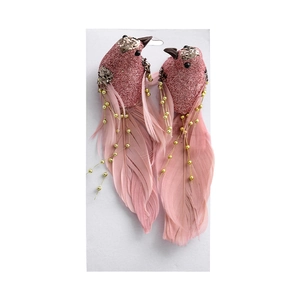 Pair of pink glitter feather bird ornaments for Christmas tree decoration on white background