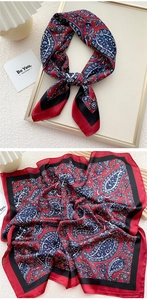 Macro detail of paisley pattern square silk scarf with elegant satin finish and black border