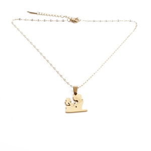 Detail of gold-plated stainless steel mother and child silhouette pendant on necklace