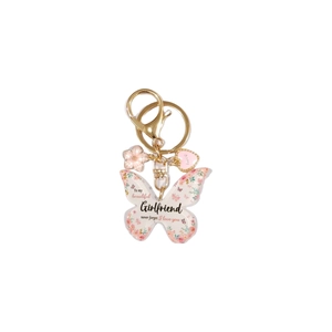 Détail du porte-clés papillon en acrylique avec motif floral rose et message d'amour gravé