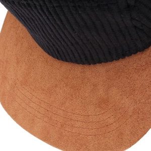 Detail of black corduroy and brown faux suede brim on a retro flat bill cap